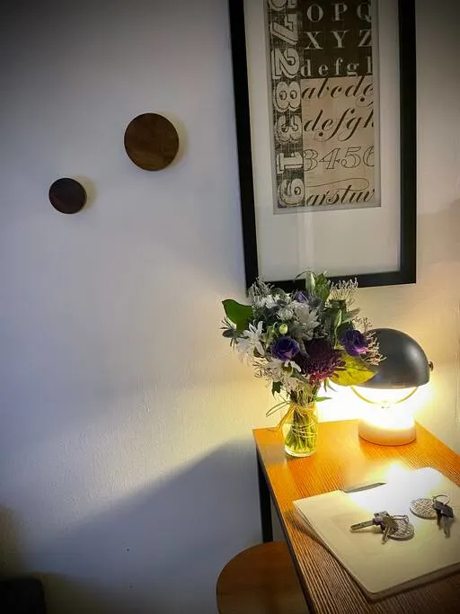 Cozy decor with flowers and artwork.