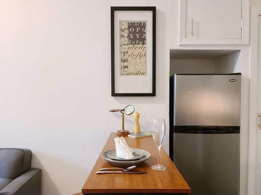 Compact kitchen with modern fridge.