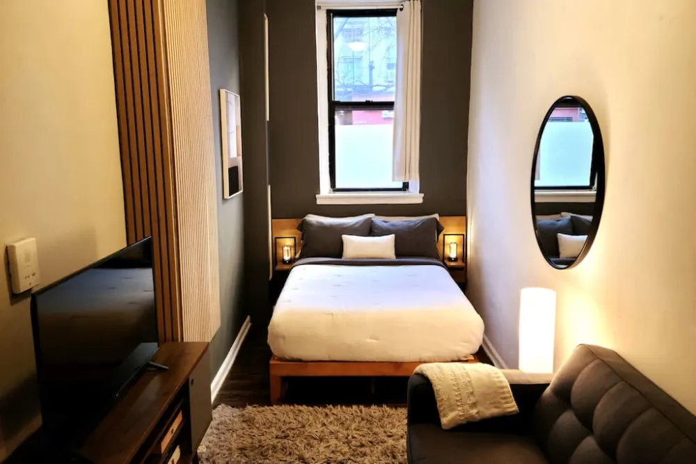 Cozy modern bedroom with TV.