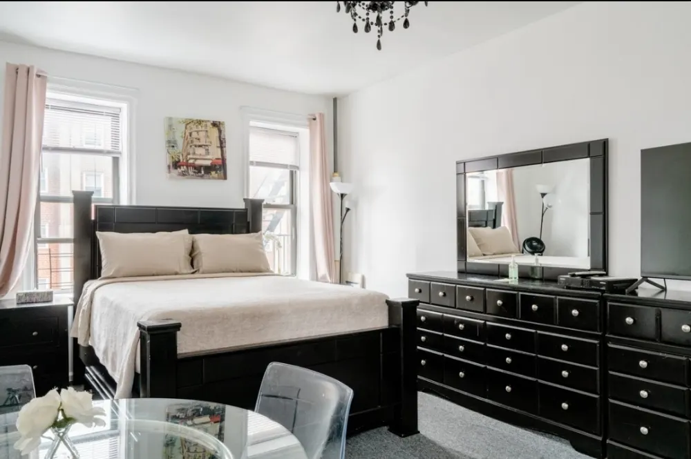 Modern, bright bedroom with dresser