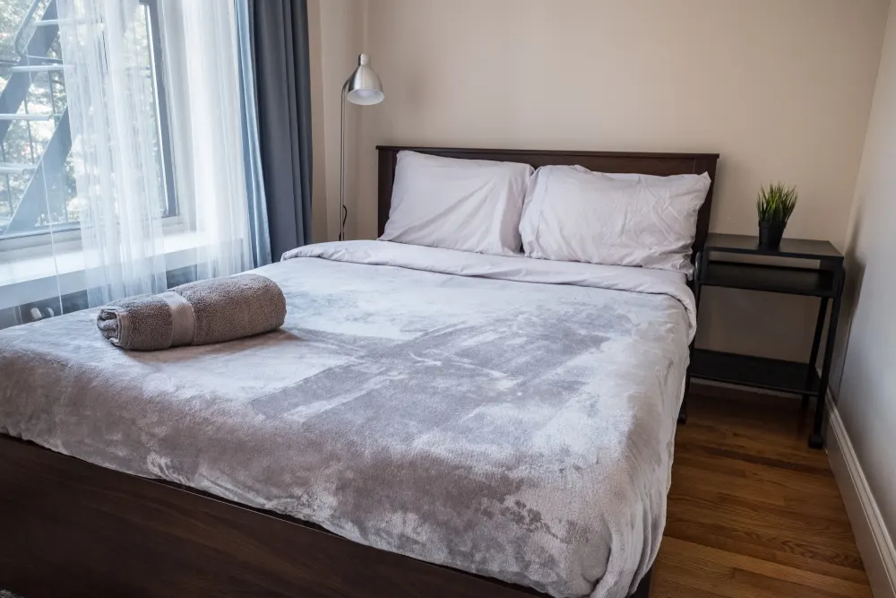 Cozy bedroom with plush bedding.