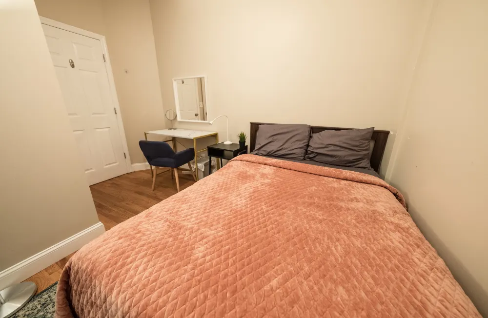 Cozy bedroom with workspace corner.