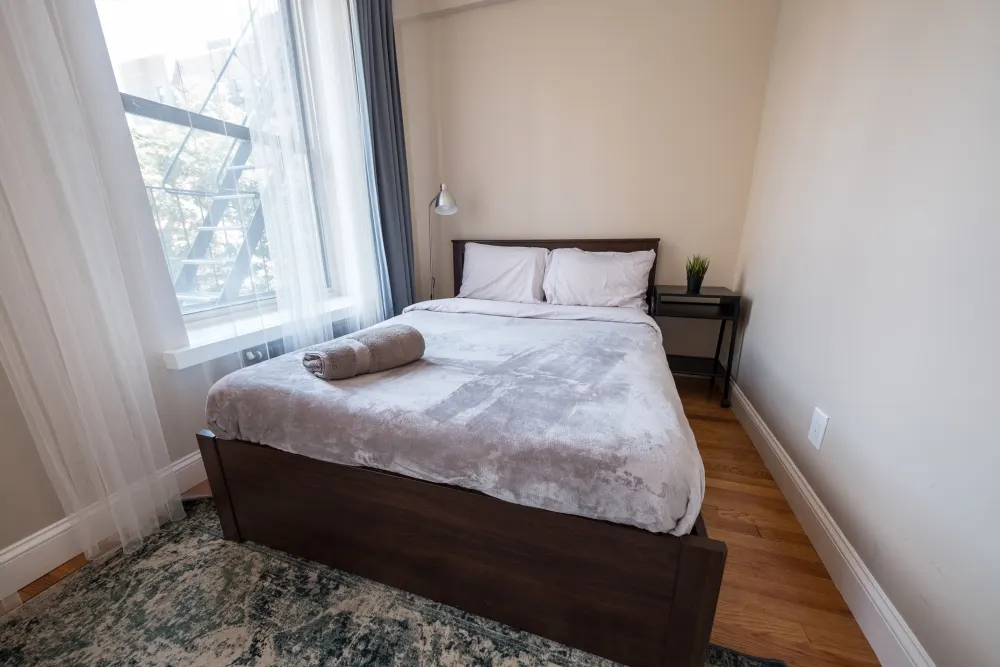 Cozy bedroom with large window.