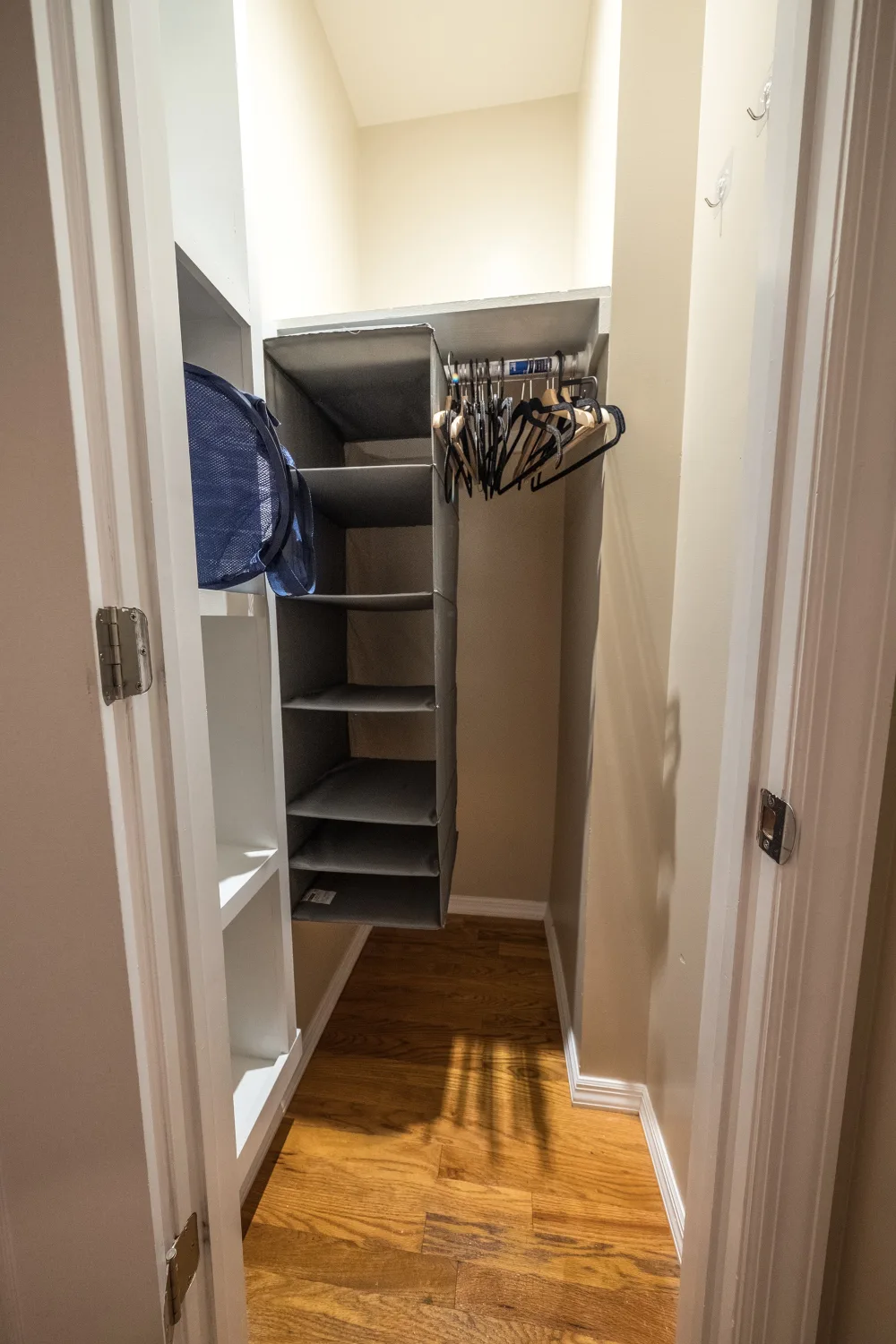 Walk-in closet with hanging storage.