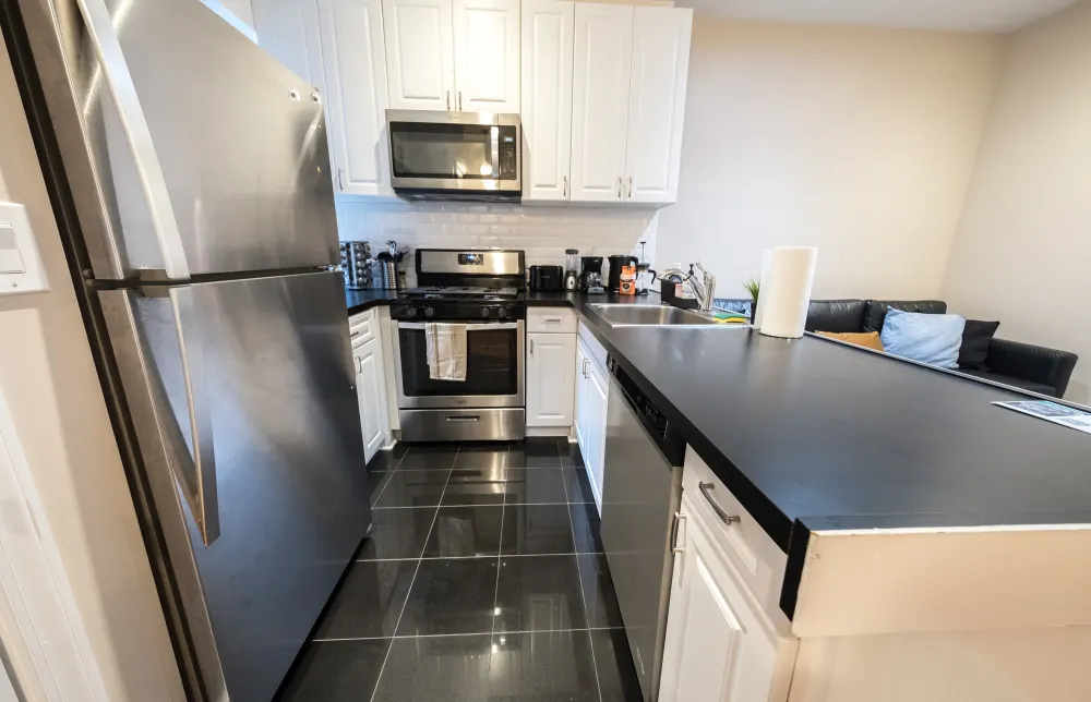 Modern kitchen with stainless appliances.