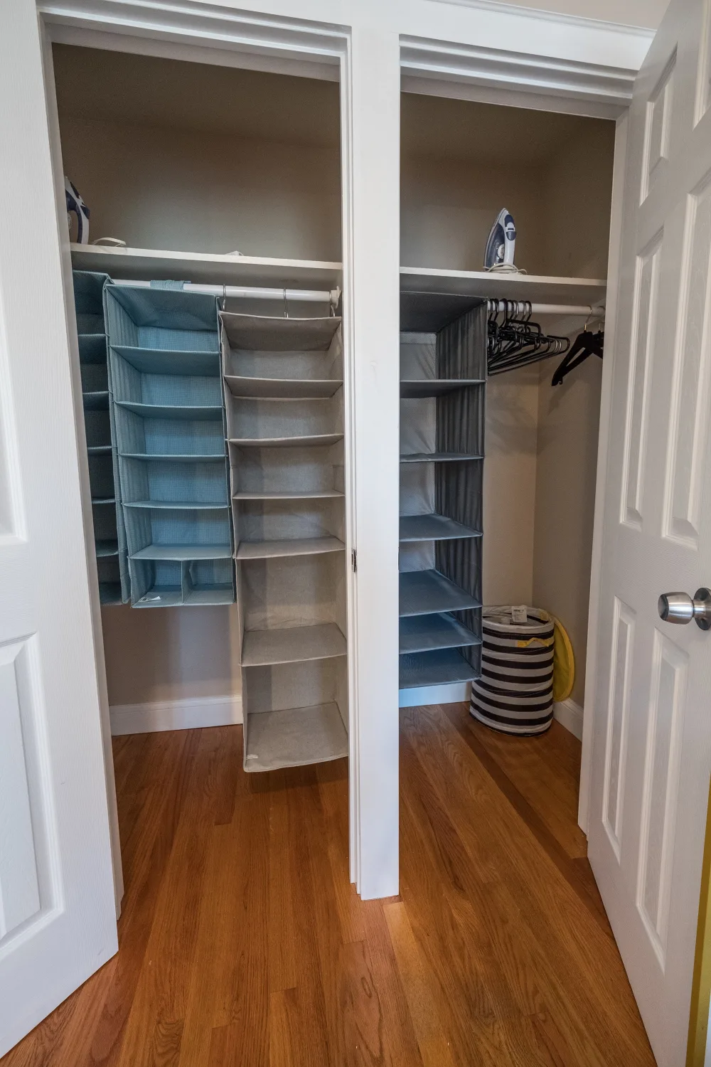 Organized closet with hanging shelves.