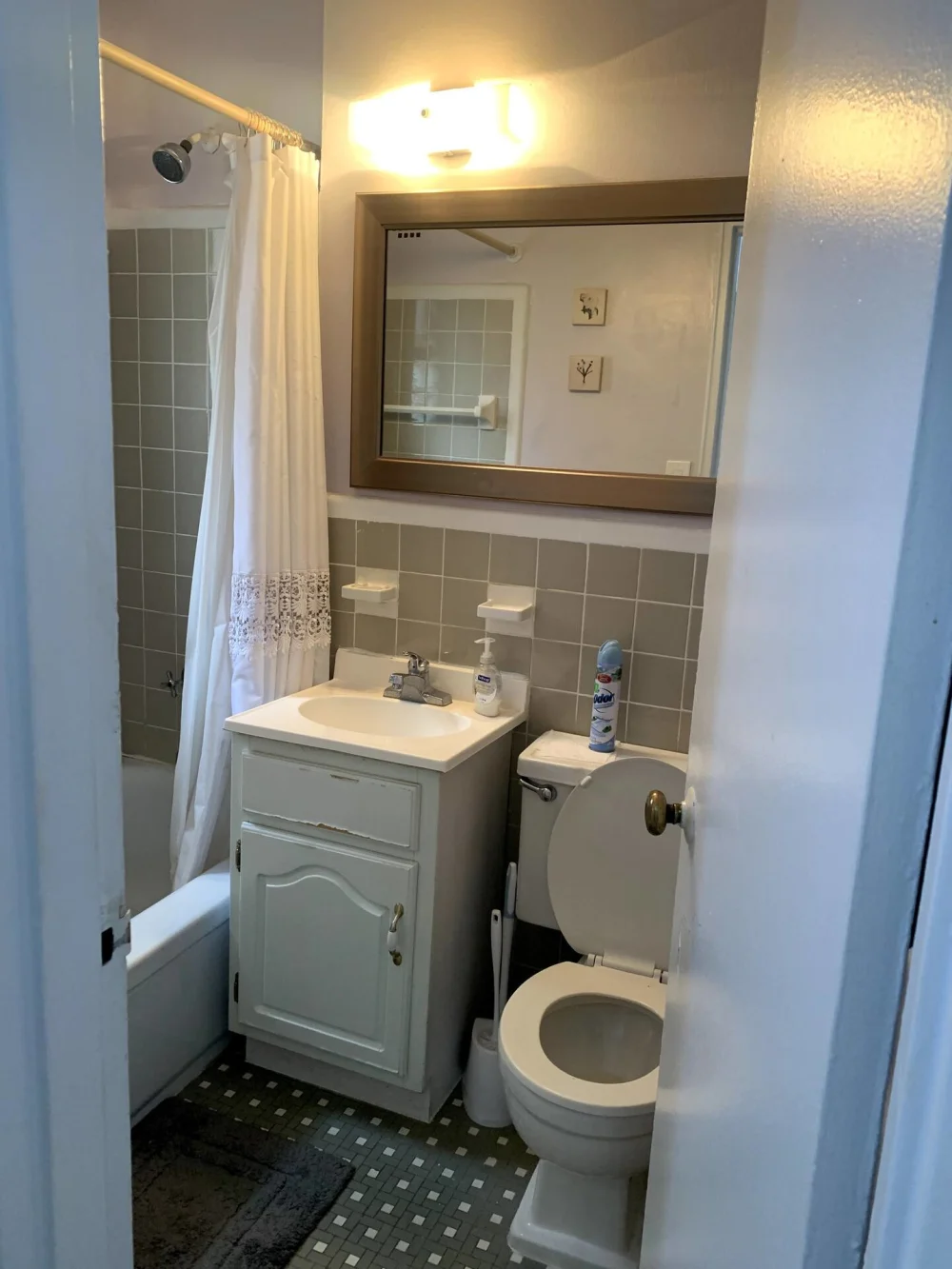 Compact, tidy bathroom with shower.