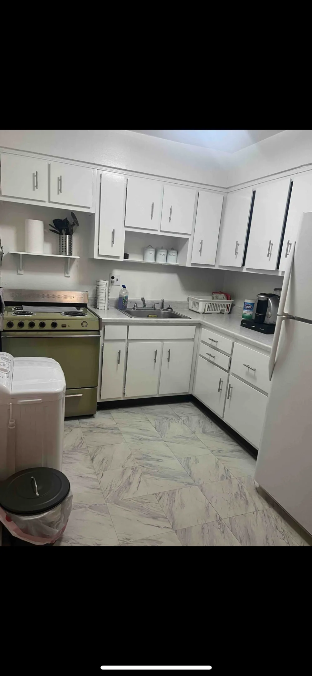 Cozy kitchen with white cabinets.