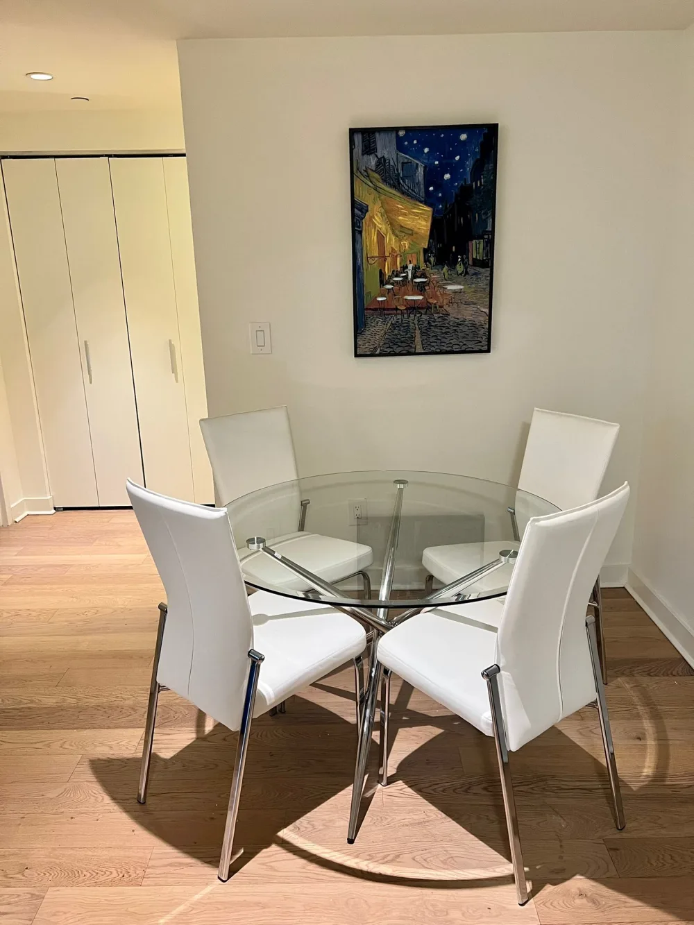 Modern dining area with artwork.