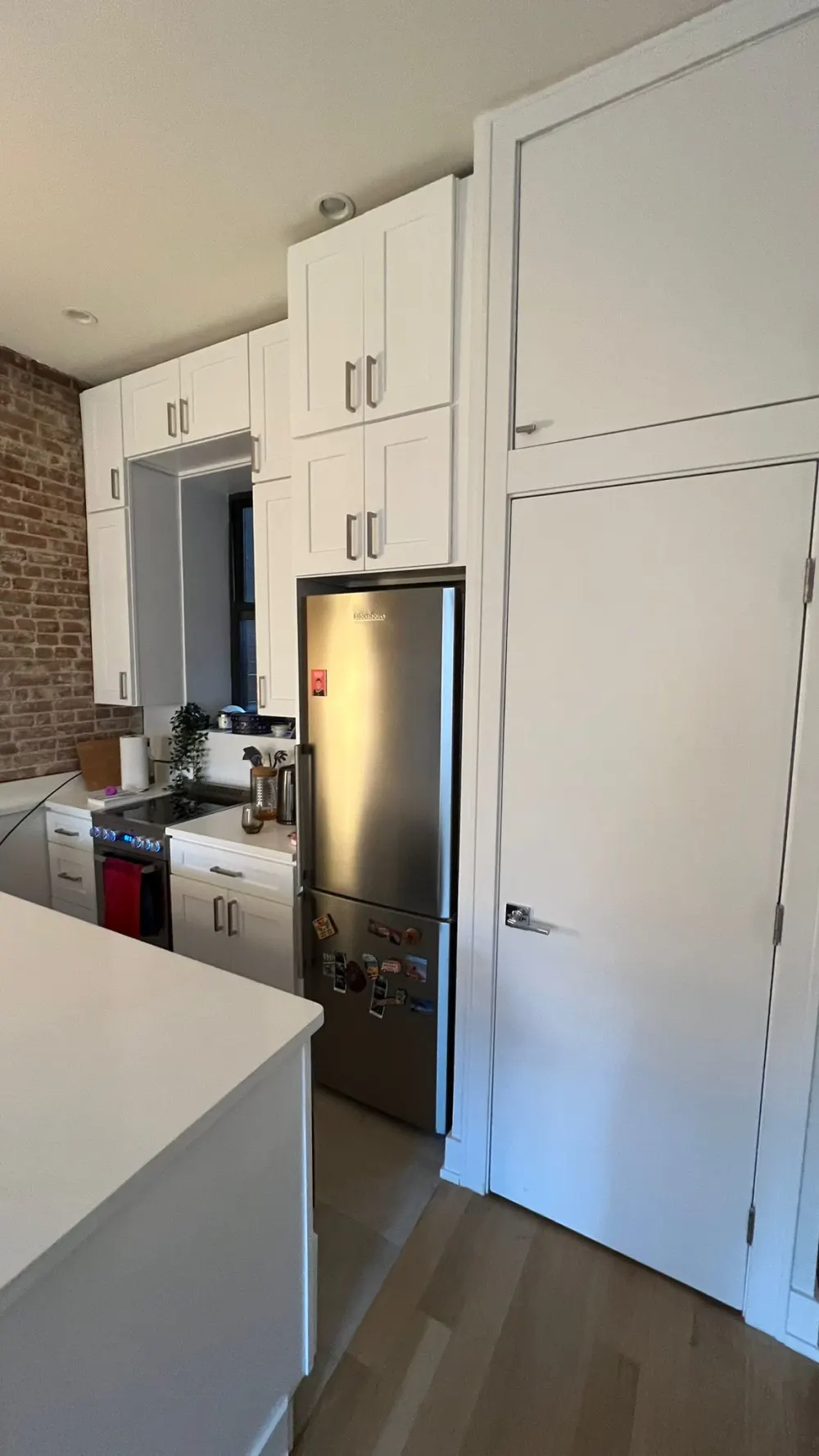 Modern kitchen with stainless appliances.