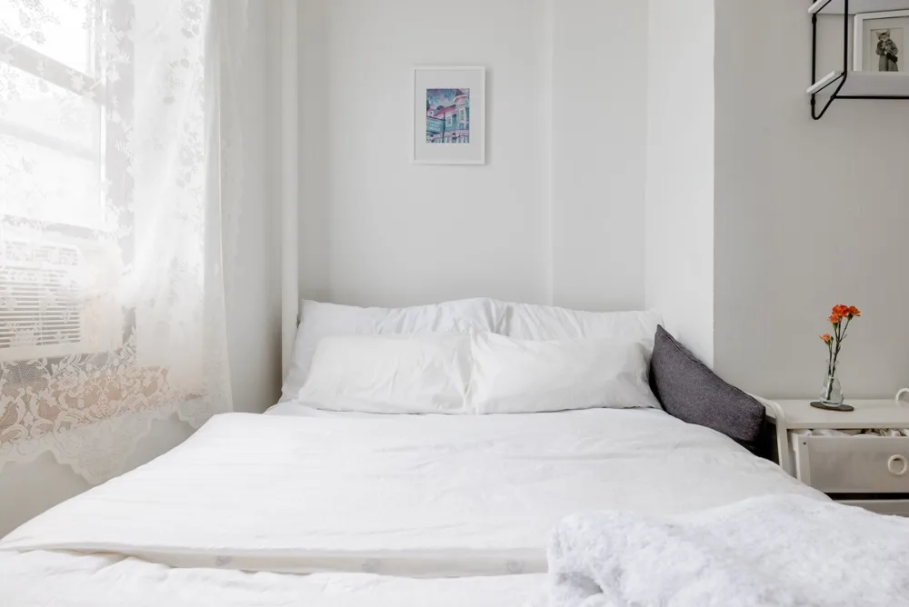 Bright, cozy bedroom with flowers.