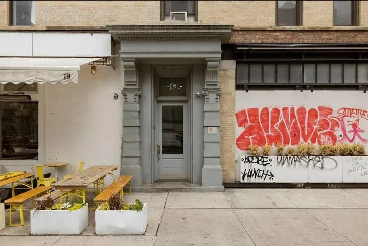 Urban entrance with outdoor seating.