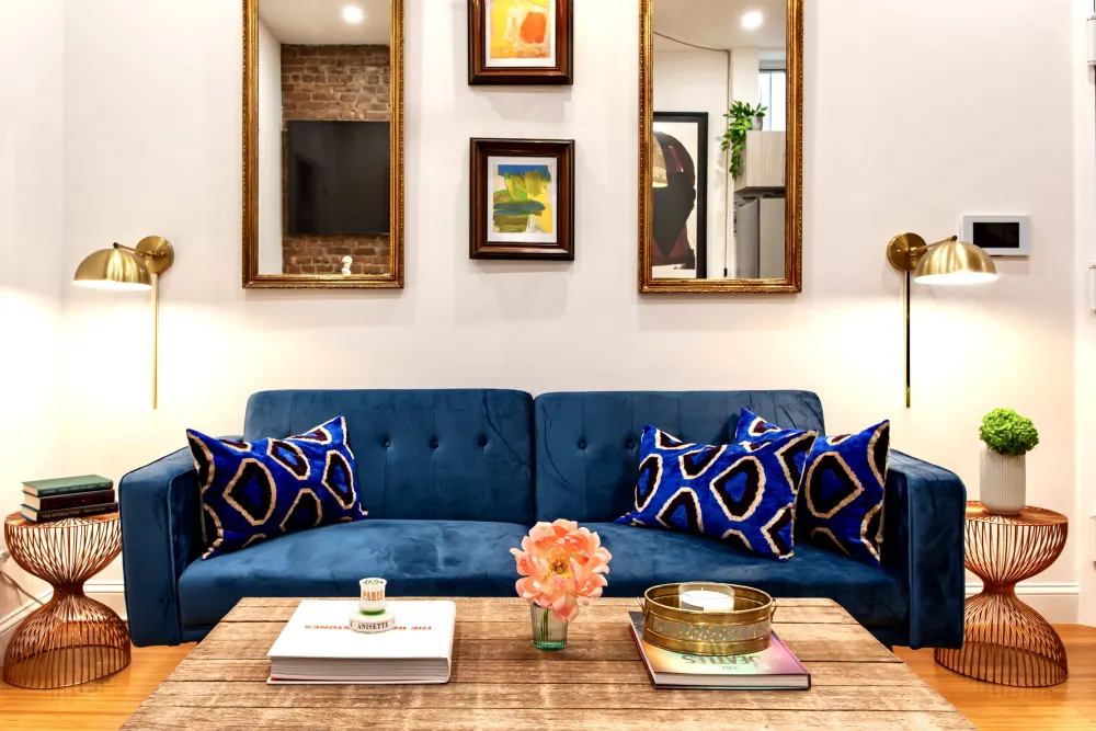 Blue velvet sofa, patterned pillows