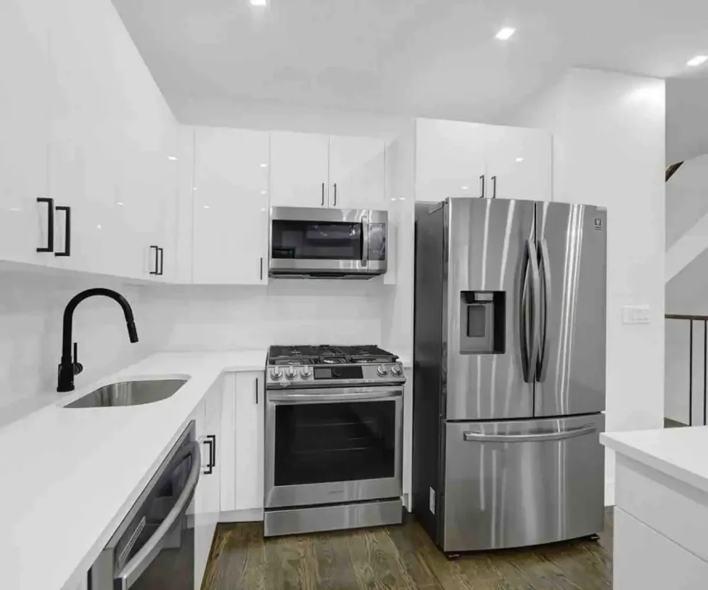 Modern kitchen with stainless appliances.