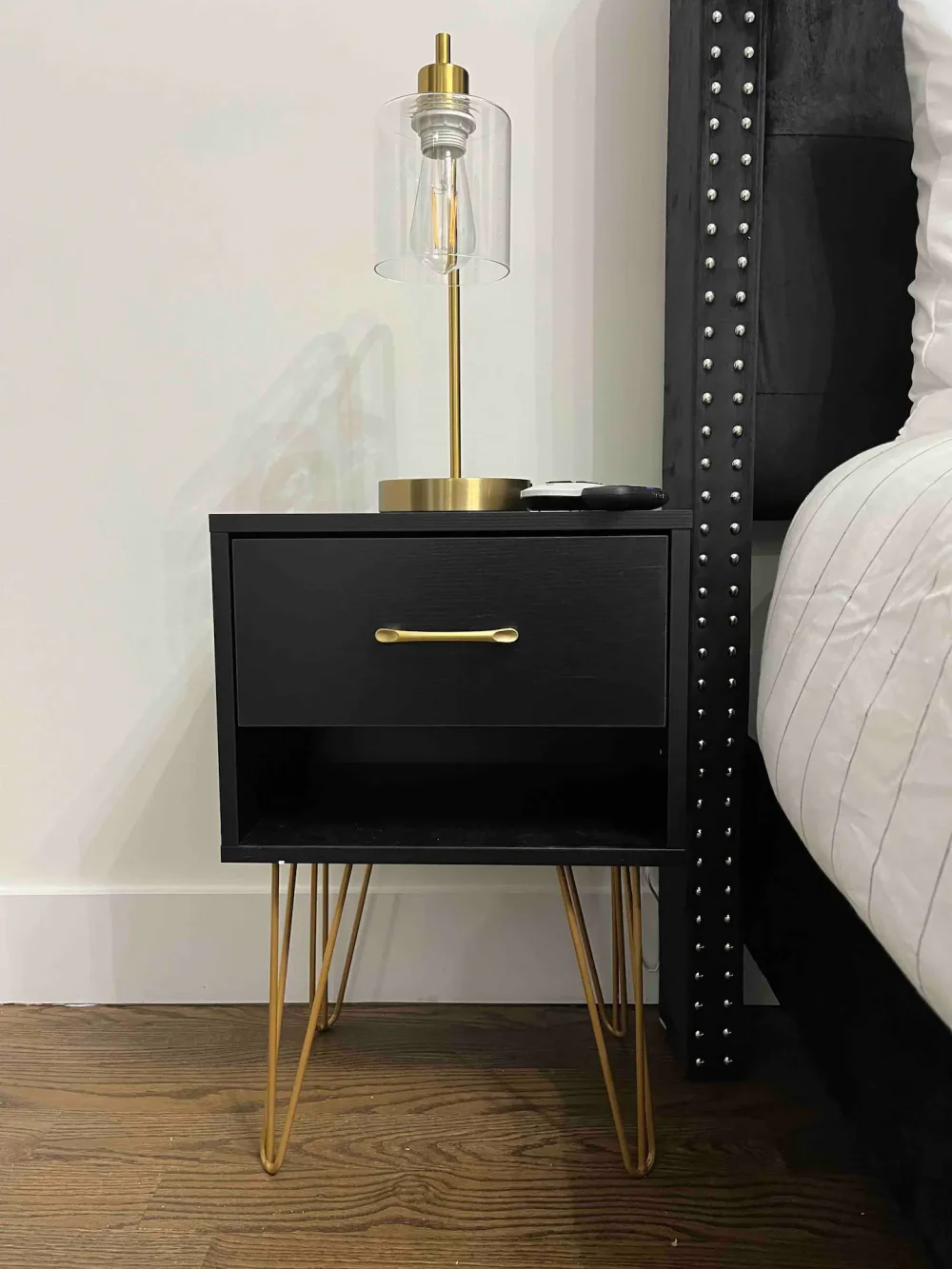 Stylish nightstand with elegant lamp.