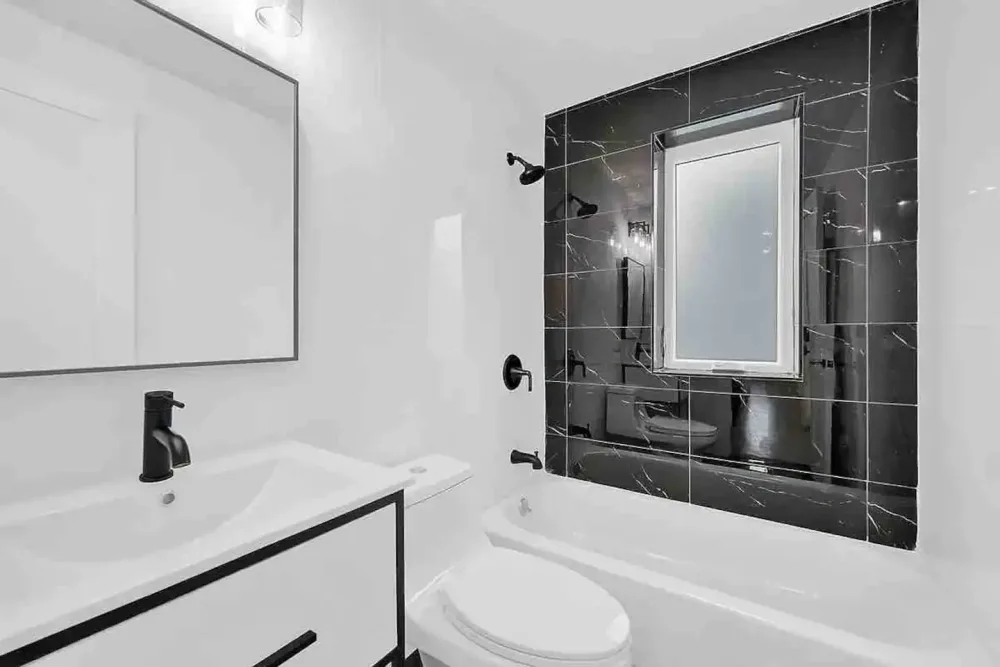 Modern bathroom with black accents.