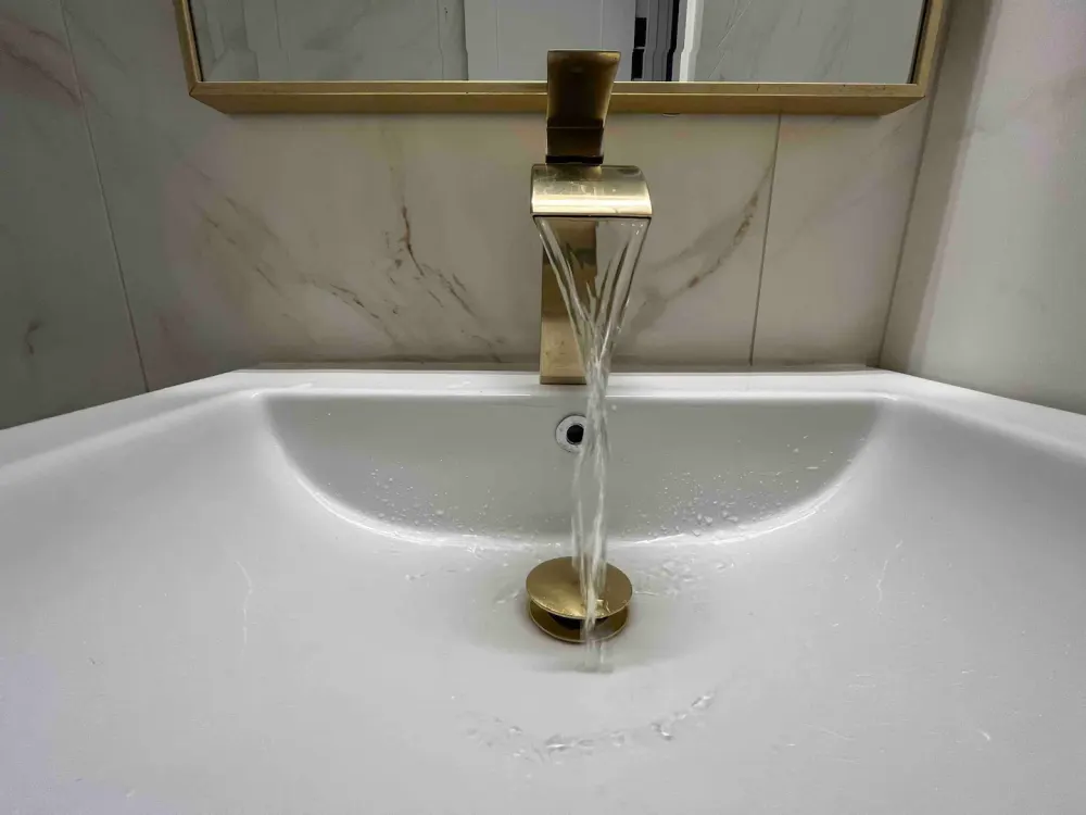 Water flowing from modern faucet.