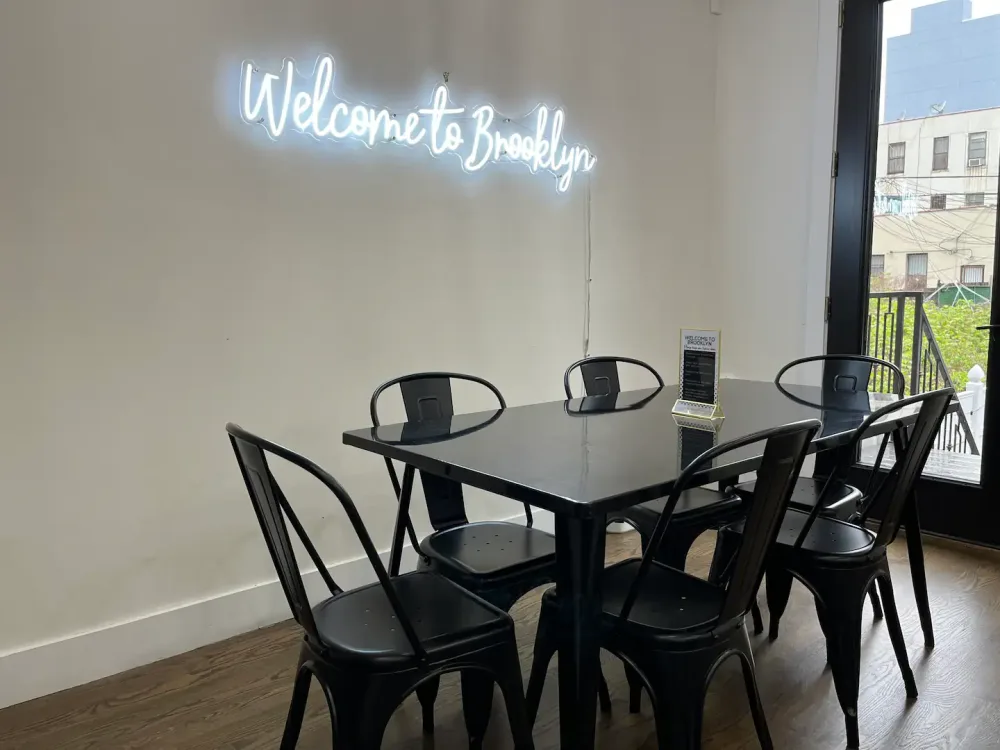 Modern dining area, "Welcome to Brooklyn" sign.