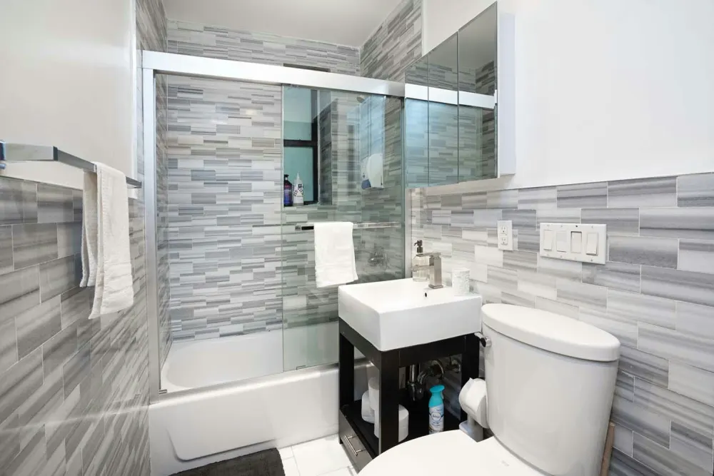 Modern bathroom with grey tiles.
