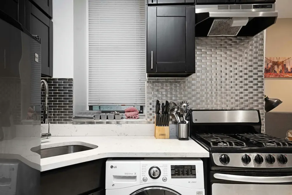 Modern kitchen with stainless appliances.