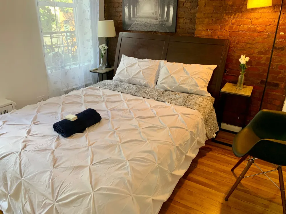 Cozy bedroom with brick wall.