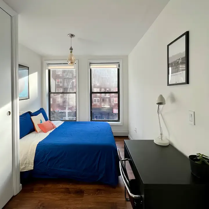 Modern, cozy bedroom with desk.