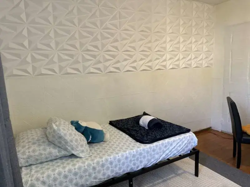 Cozy single bed, geometric wall