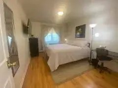 Cozy light-filled bedroom with bed