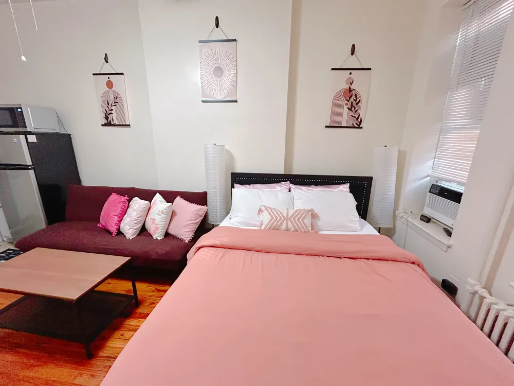 Cozy room with pink bedding.