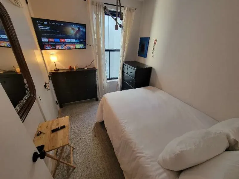 Cozy compact bedroom with TV