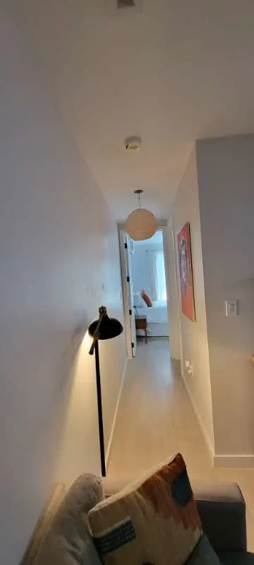 Narrow hallway with floor lamp