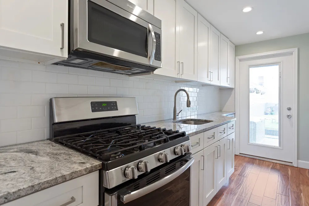 Modern kitchen with stainless appliances.