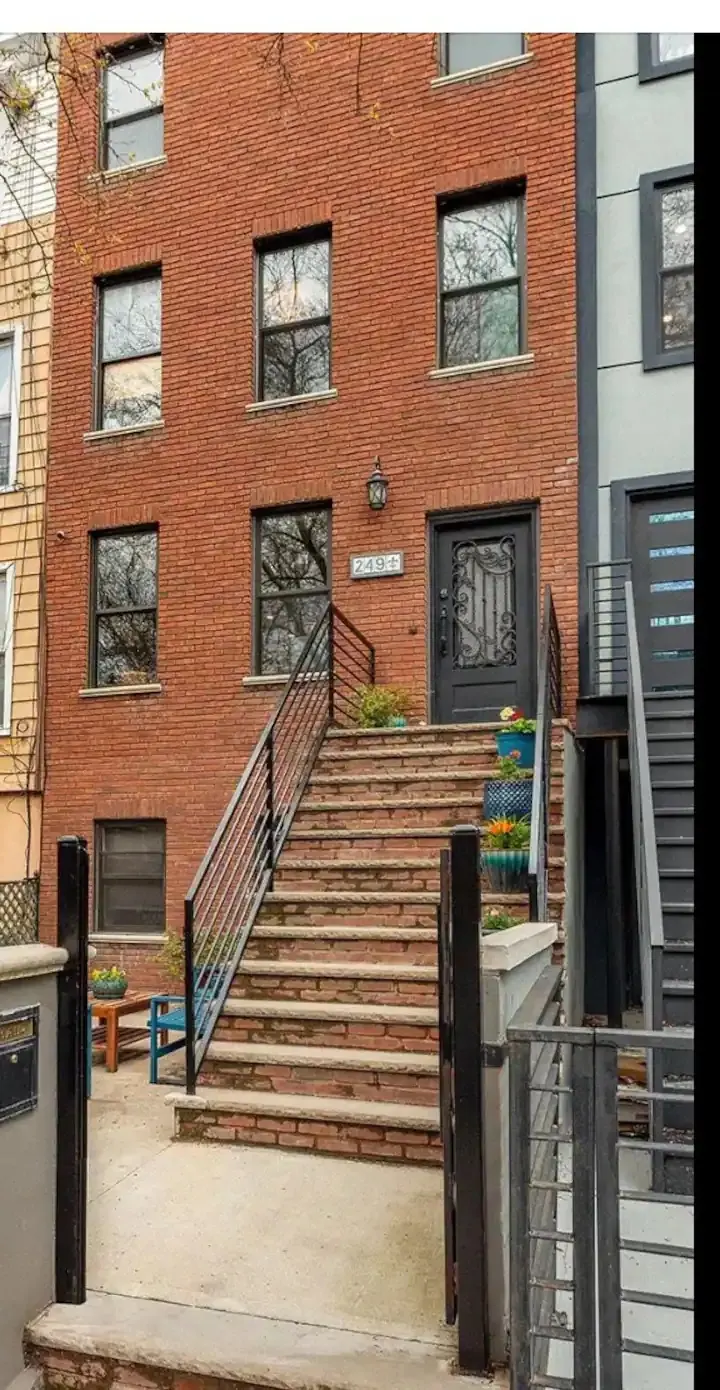 Brick townhouse with front steps.