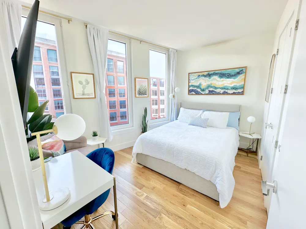 Sunlit modern bedroom, urban views