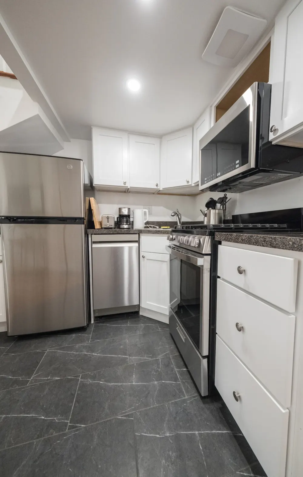 Modern kitchen with stainless steel appliances.
