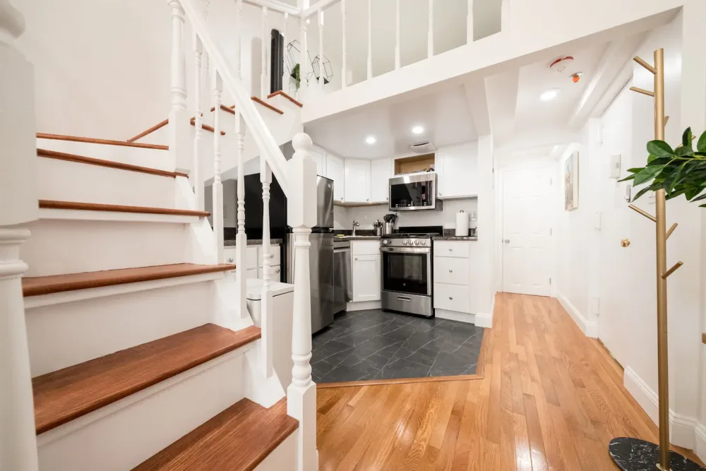 Modern kitchen with loft-style staircase.