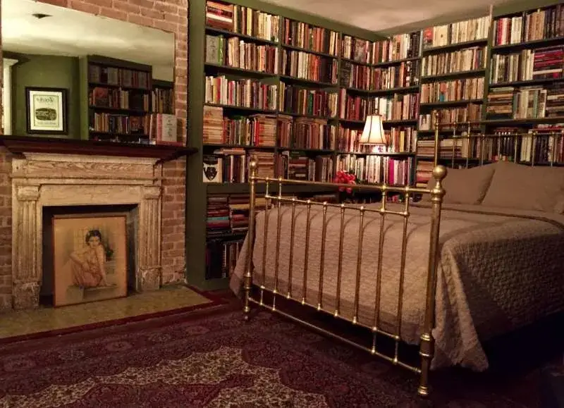 Cozy bedroom lined with bookshelves