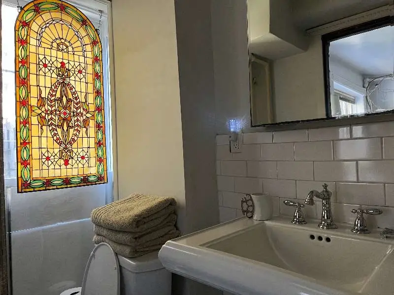 Bathroom sink, towels, stained-glass window