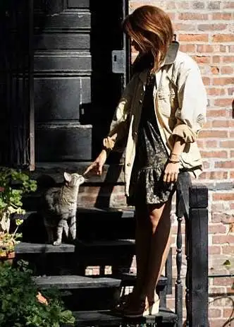 Woman petting cat on steps