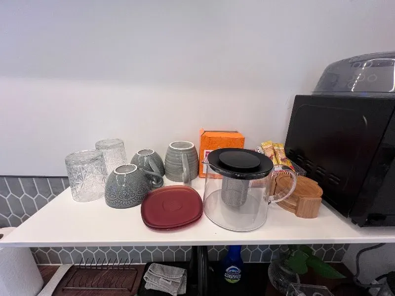 Mugs, teapot, and glasses arranged