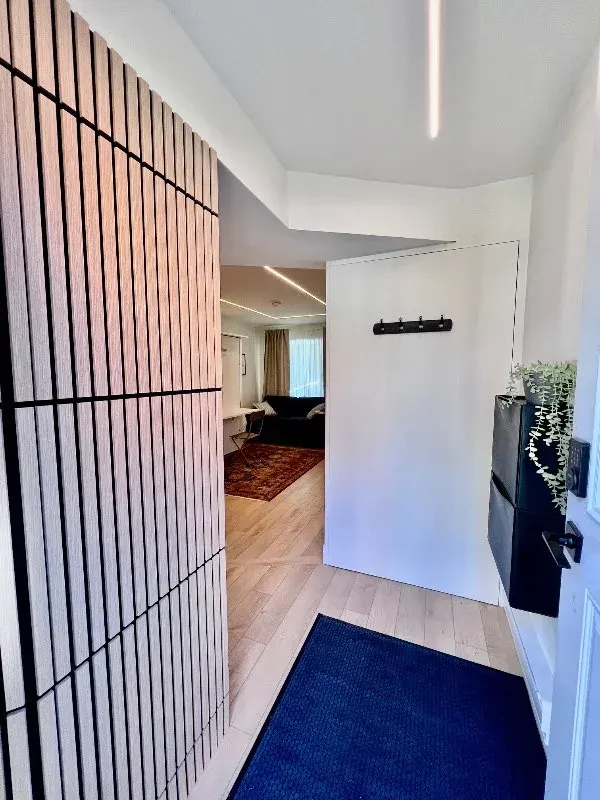 Modern entryway with wood slats