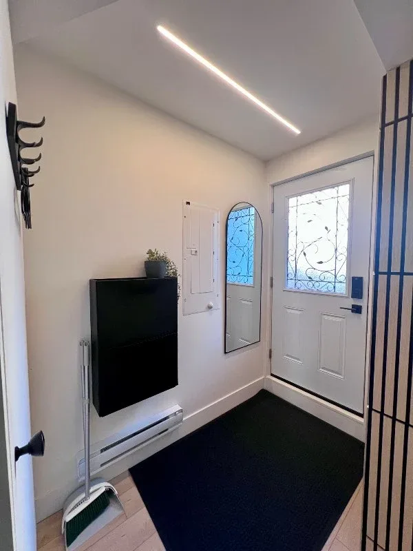 Bright modern entryway with mirror