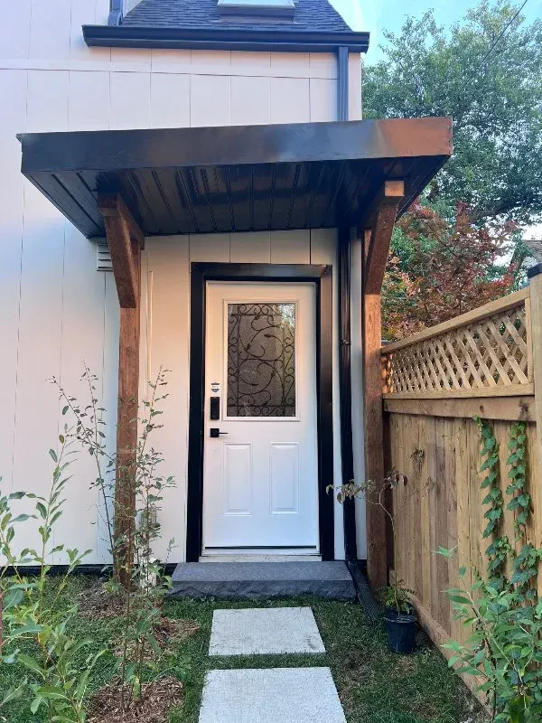 White door beneath wooden porch