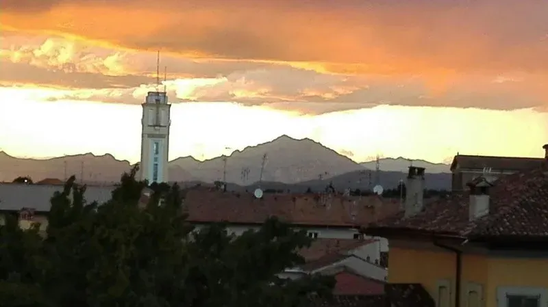 Sunset over rooftops and mountains