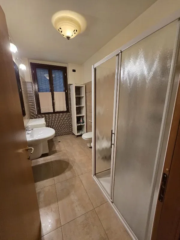 Small tiled bathroom with shower