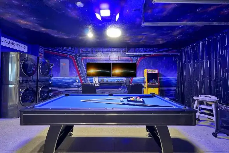 Space-themed game room with pool