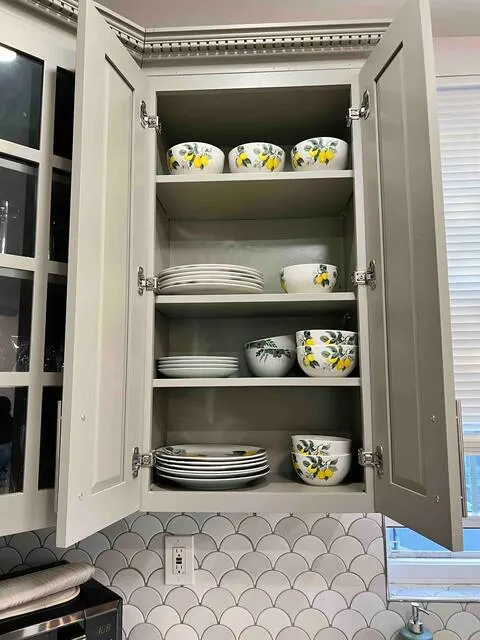 Gray kitchen cabinet with dishes