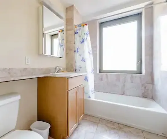 Bright bathroom with large window.