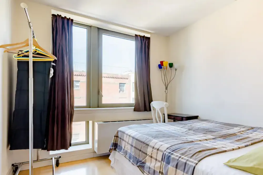 Bright cozy bedroom with windows.