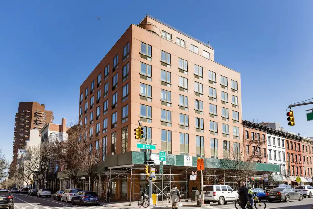 Modern hotel exterior on street corner.